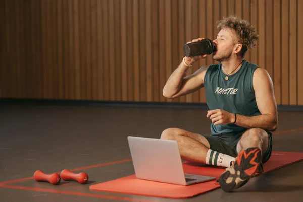 Personal trainer using program builder software to create custom workout programs