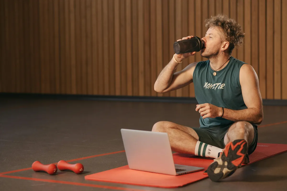 Personal trainer using program builder software to create custom workout programs