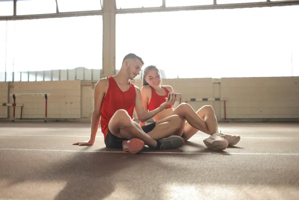 Personal trainer sending workout programs to clients online using digital platform