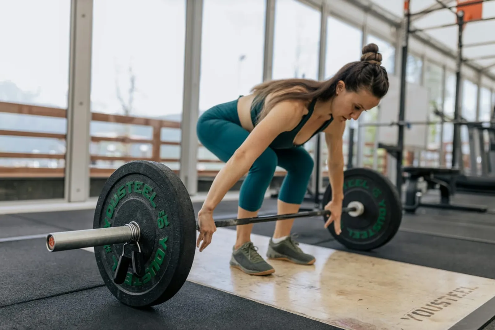 Personal trainer working with diverse clients in gym