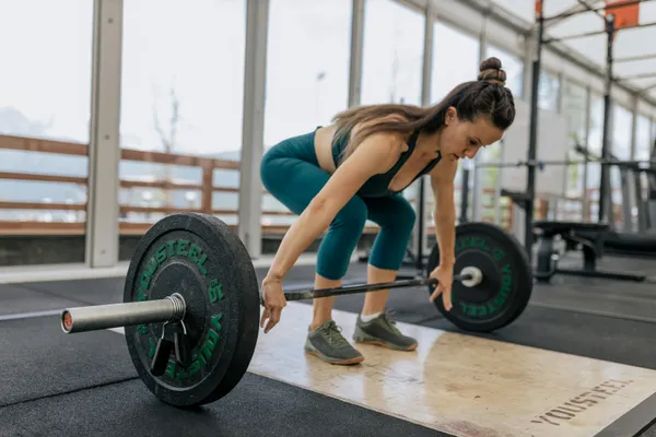 Personal trainer working with diverse clients in gym
