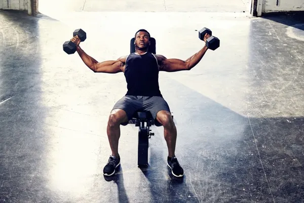 Personal trainer celebrating client success in gym